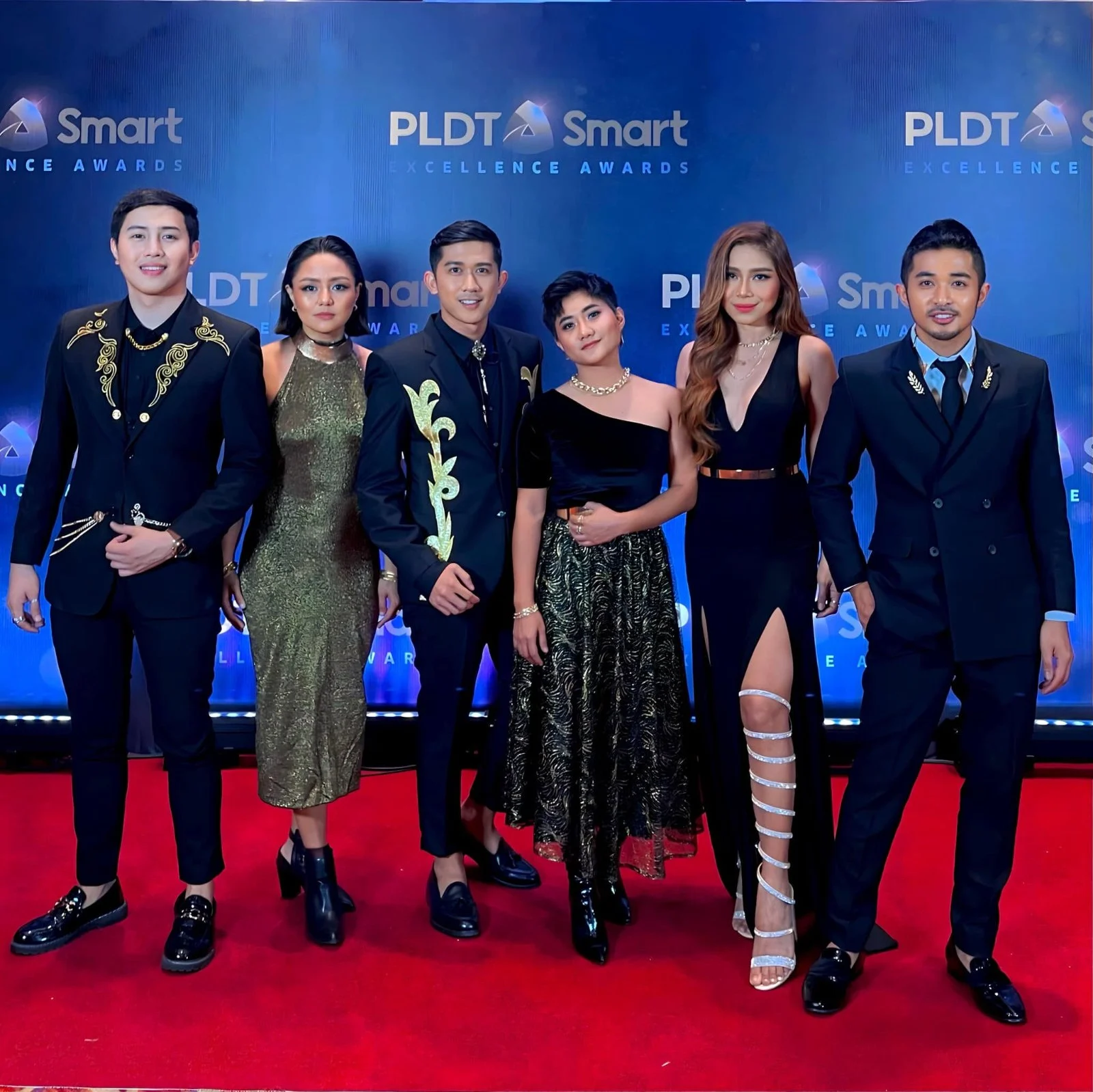 Pinopela on a red carpet in formal wear